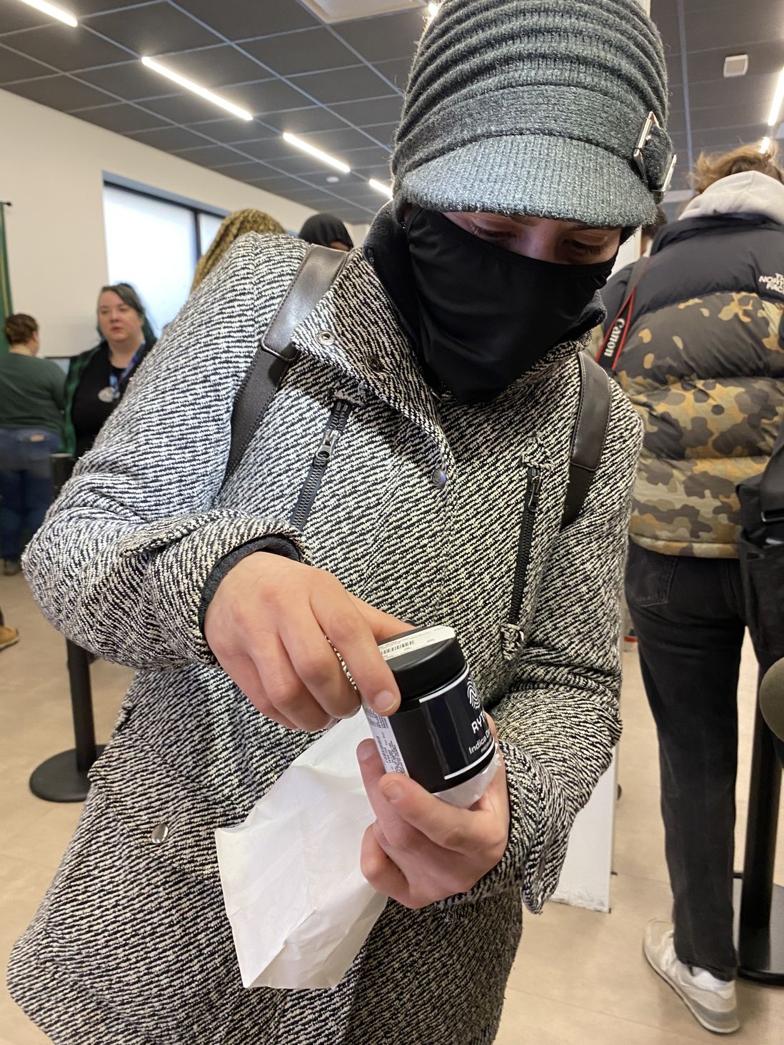 Melissa Correa, 42, the first person in line when the RISE dispensary in Bloomfield opened at 6 a.m., showing off her purchase, April 21st, 2022.